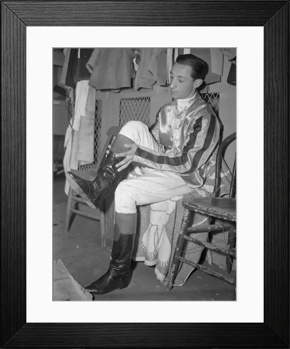 Framed Print : Eddie Arcaro Pulling on Riding Boots Framed Print : Eddie Arcaro Pulling on Riding Boots