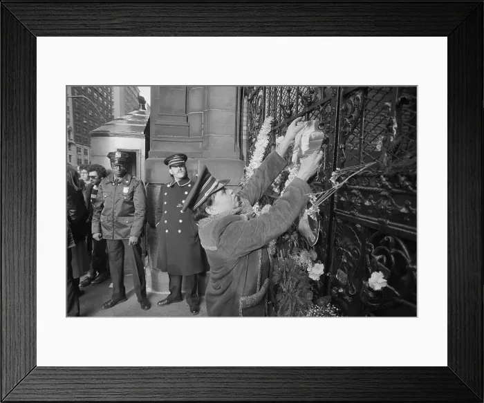 Framed Print : Mourner Affixing Photo to Door Framed Print : Mourner Affixing Photo to Door