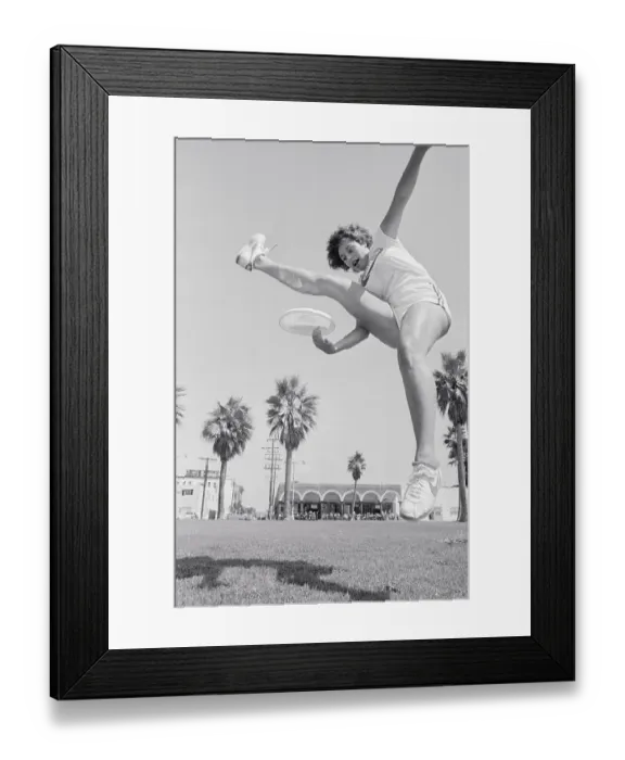 Framed Print : Laura Engel Catching Frisbee Through Her Legs Framed Print : Laura Engel Catching Frisbee Through Her Legs