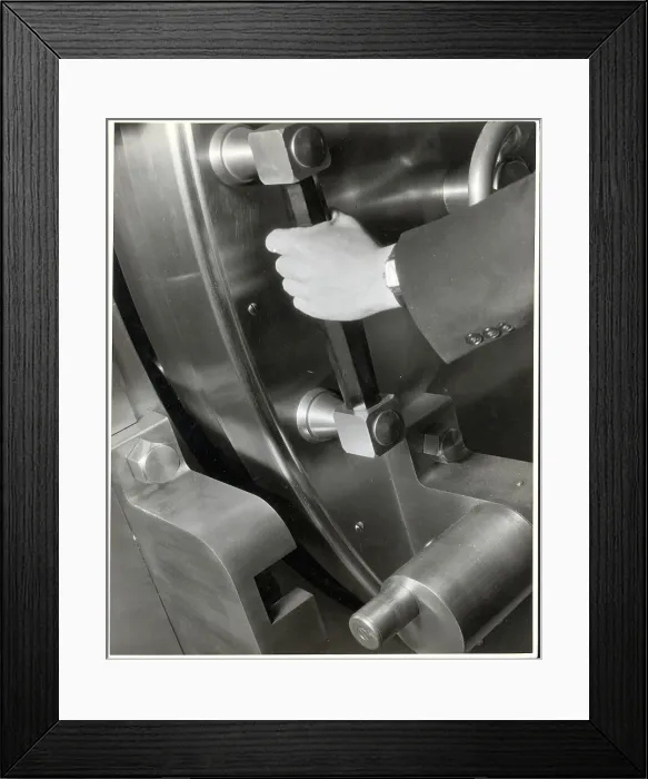 Framed Print : A Man Closes A Large Bank Vault Framed Print : A Man Closes A Large Bank Vault