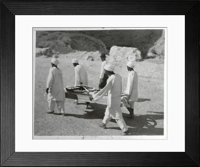 Framed Print : Workers Carrying Chariot Wheels on Stretcher Framed Print : Workers Carrying Chariot Wheels on Stretcher
