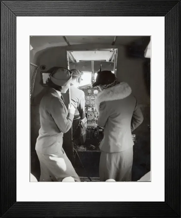 Framed Print : Flight Attendant Shows Woman Cockpit