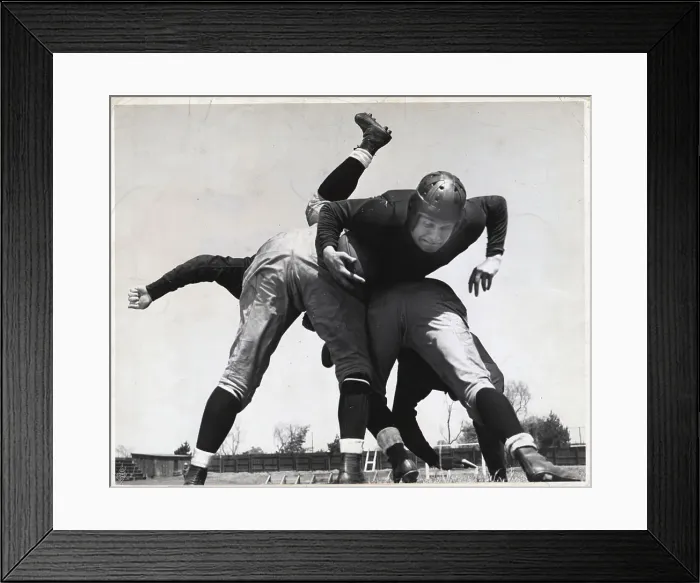 Framed Print : Football Player Bring Tackled Framed Print : Football Player Bring Tackled
