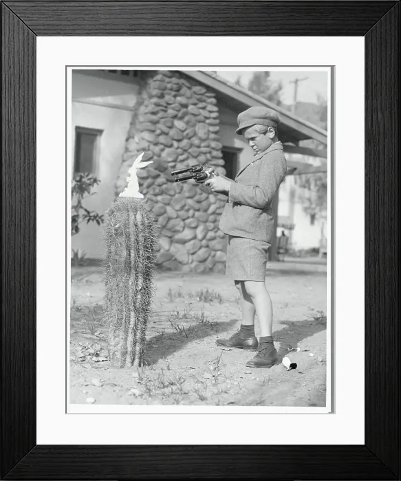 Framed Print : Jackie Cooper Aiming a Gun Framed Print : Jackie Cooper Aiming a Gun