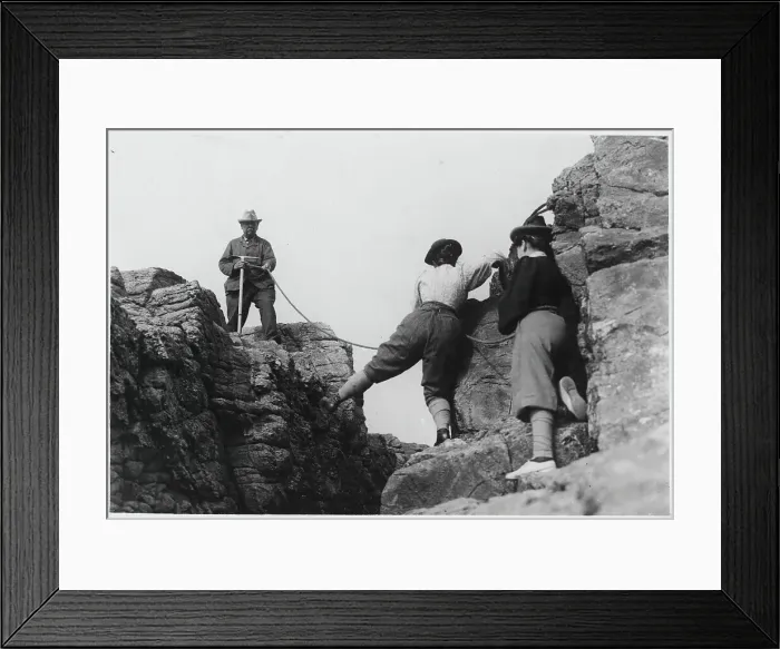 Framed Print : Man Helping Women on Mountainous Rock Framed Print : Man Helping Women on Mountainous Rock