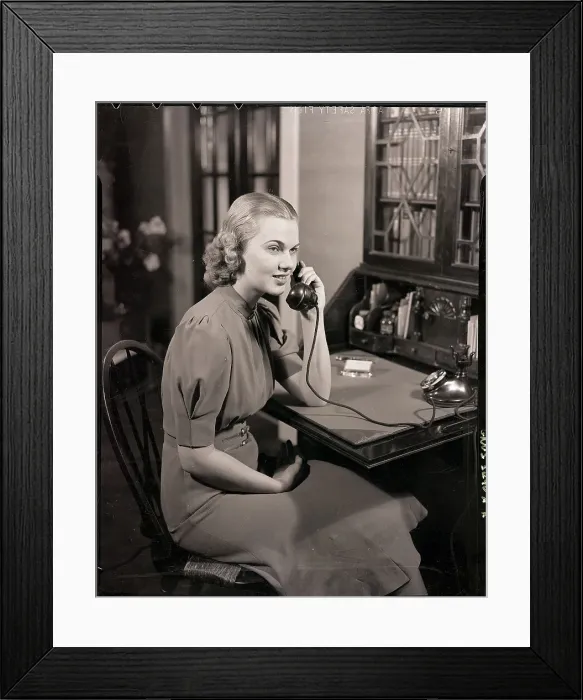 Framed Print : Woman Seated At Desk / Talking On Phone Framed Print : Woman Seated At Desk / Talking On Phone