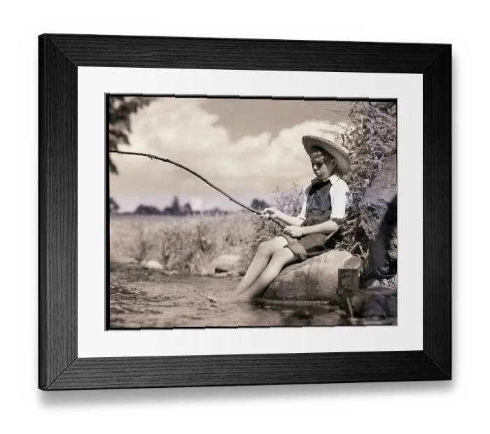 Framed Print : Boy Seated Fishing In Stream