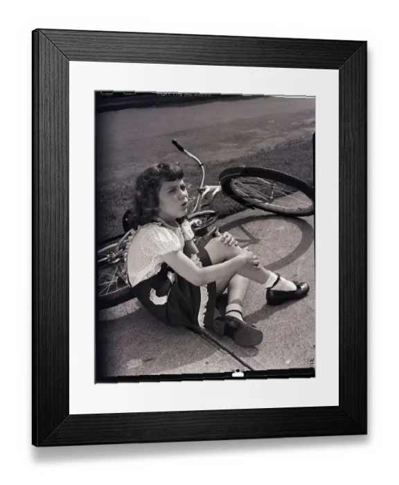 Framed Print : Girl Holding Leg After Falling off Bike Framed Print : Girl Holding Leg After Falling off Bike