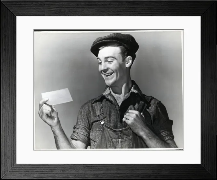 Framed Print : Close-Up Working Man Smiling At Paper Framed Print : Close-Up Working Man Smiling At Paper