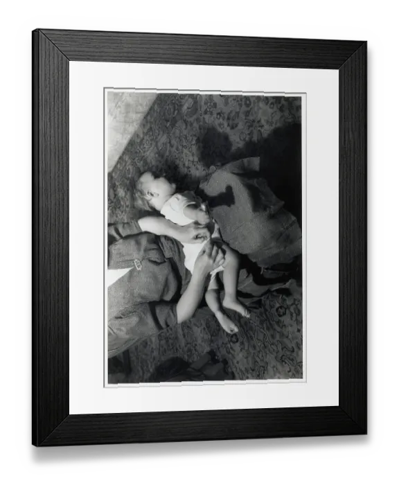 Framed Print : Mother Pinning Diaper On Baby in Lap Framed Print : Mother Pinning Diaper On Baby in Lap