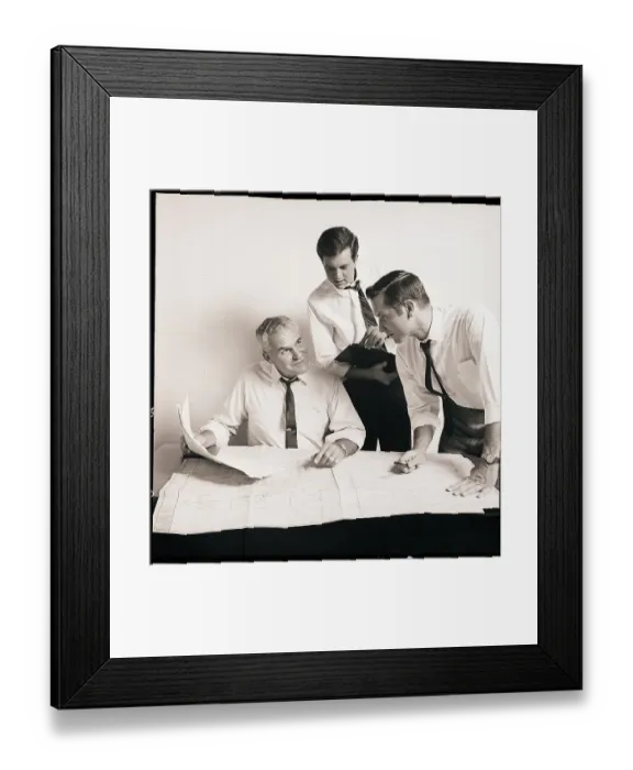 Framed Print : Businessmen Examine A Blueprint Framed Print : Businessmen Examine A Blueprint