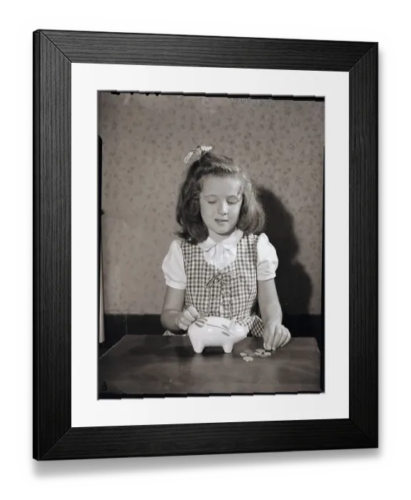 Framed Print : Girl Putting Change Into Piggy Bank Framed Print : Girl Putting Change Into Piggy Bank