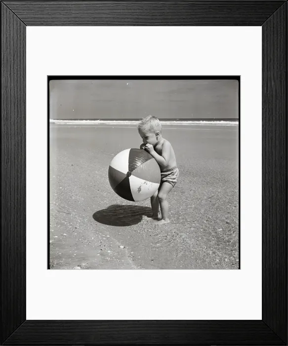Framed Print : Boy Blowing up Beach Ball Framed Print : Boy Blowing up Beach Ball