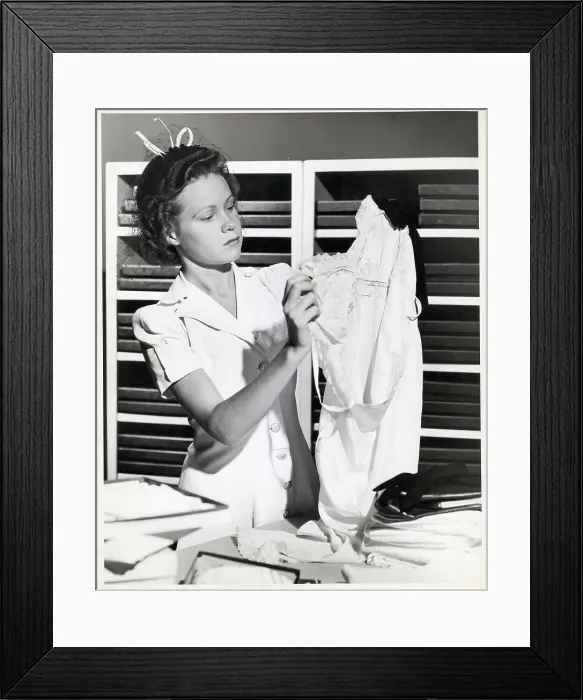 Framed Print : Woman Holds Up Nightgown While Shopping Framed Print : Woman Holds Up Nightgown While Shopping
