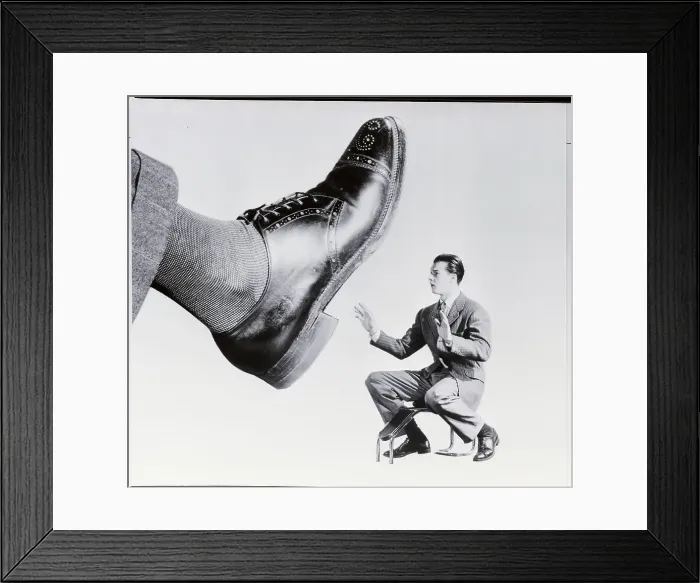 Framed Print : Shoe Salesman Faced with Giant Shoe Framed Print : Shoe Salesman Faced with Giant Shoe