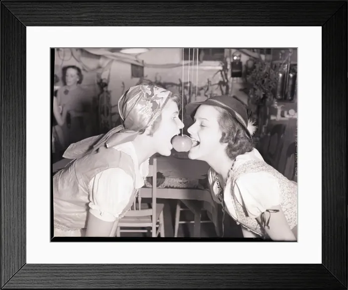 Framed Print : Girls Biting into Hanging Apple Framed Print : Girls Biting into Hanging Apple