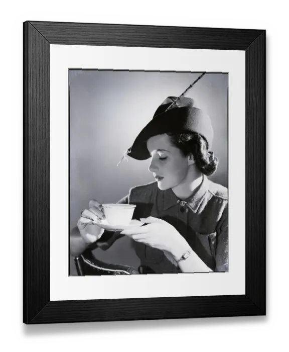 Framed Print : Vintage photograph of young woman holding cup of coffee Framed Print : Vintage photograph of young woman holding cup of coffee