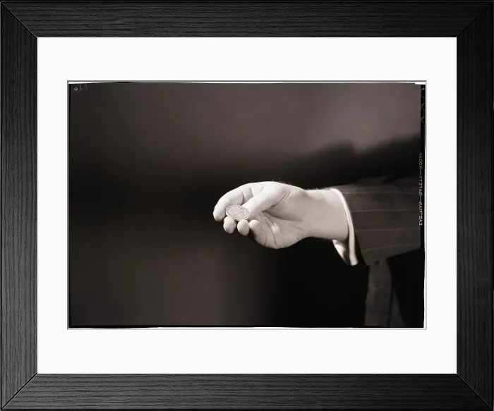 Framed Print : Close-Up Of Man's Hand Flipping Coin