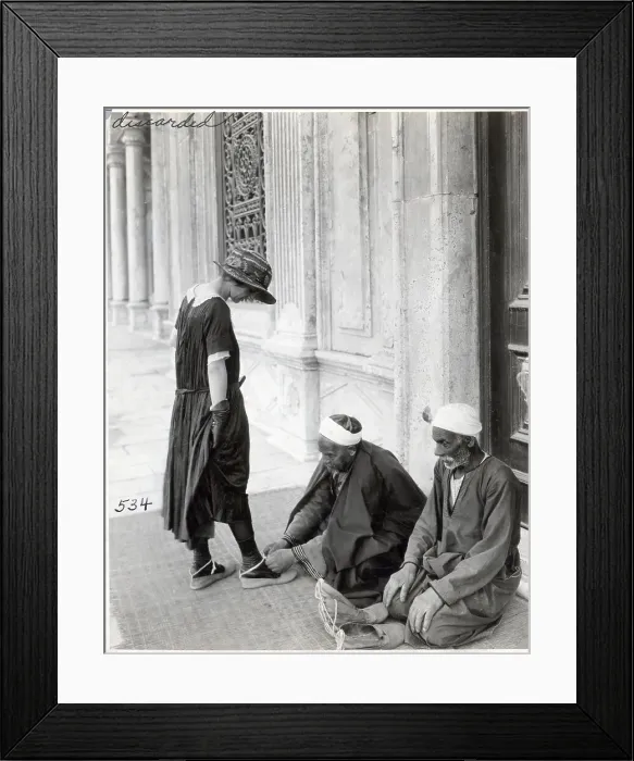 Framed Print : Man Ties Slippers on Tourist at Mosque