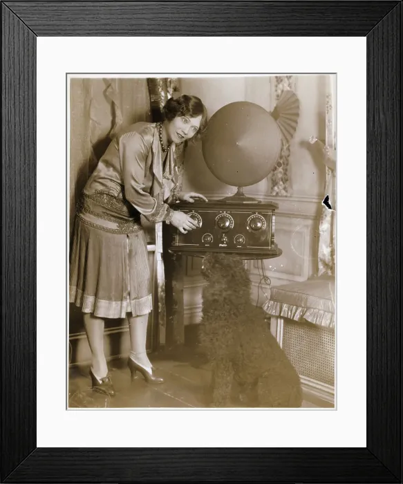 Framed Print : Woman Adjusting Dial On Early Radio Framed Print : Woman Adjusting Dial On Early Radio