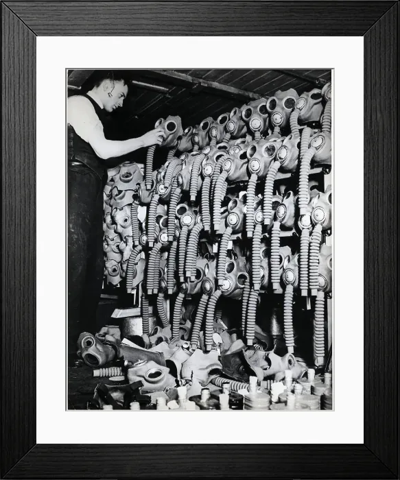 Framed Print : Man Places Mask Atop A Lot Of Gas Masks Framed Print : Man Places Mask Atop A Lot Of Gas Masks