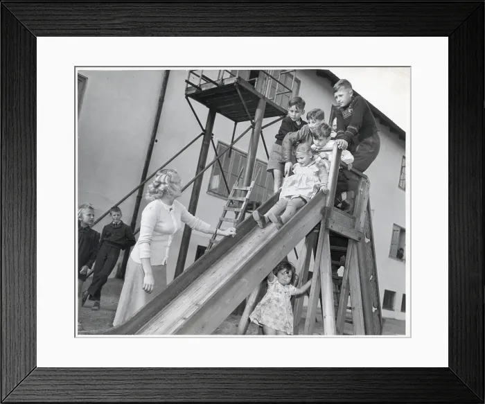 Framed Print : Woman Watching Children Play On Slide Framed Print : Woman Watching Children Play On Slide