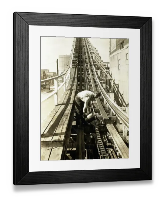 Framed Print : Man Greasing Chain Of Wood Roller Coaste Framed Print : Man Greasing Chain Of Wood Roller Coaste