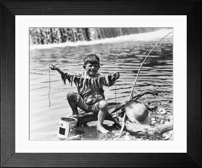 Framed Print : Boy Displays String Of Caught Fish