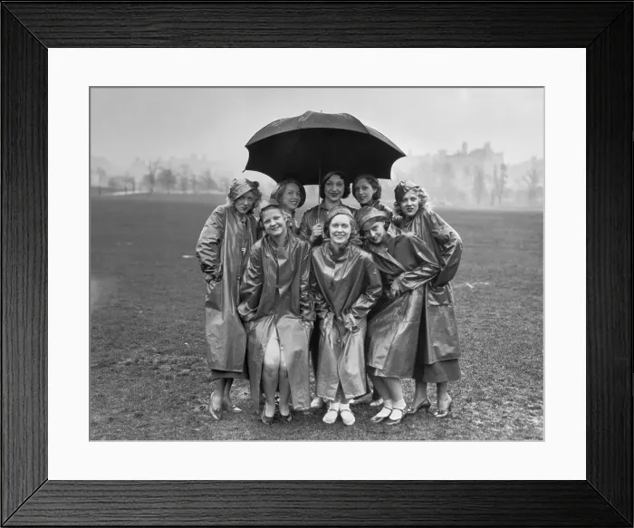Framed Print : Group of young women standing on field under umbrella Framed Print : Group of young women standing on field under umbrella
