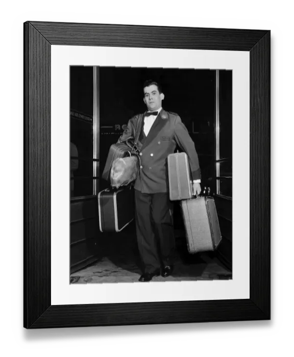 Framed Print : Bellhop Carrying Luggage Framed Print : Bellhop Carrying Luggage
