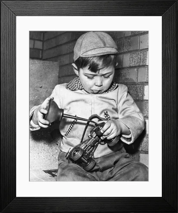 Framed Print : Boy oiling roller skates Framed Print : Boy oiling roller skates