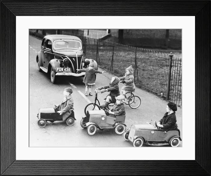 Framed Print : Children playing outside with toy cars and bicycles Framed Print : Children playing outside with toy cars and bicycles