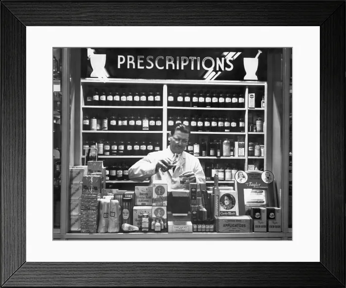 Framed Print : Pharmacist At Prescription Counter Framed Print : Pharmacist At Prescription Counter