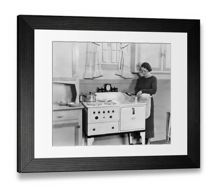 Framed Print : Woman Pouring Milk into Pot in Kitchen Framed Print : Woman Pouring Milk into Pot in Kitchen