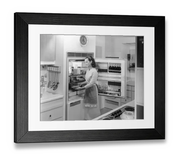 Framed Print : Woman Placing Food Into Refrigerator Framed Print : Woman Placing Food Into Refrigerator