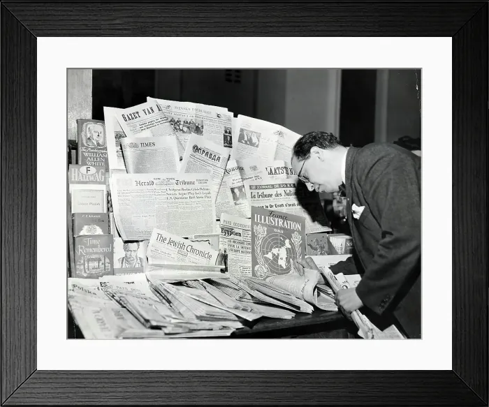 Framed Print : Man Leafs Through International News Framed Print : Man Leafs Through International News