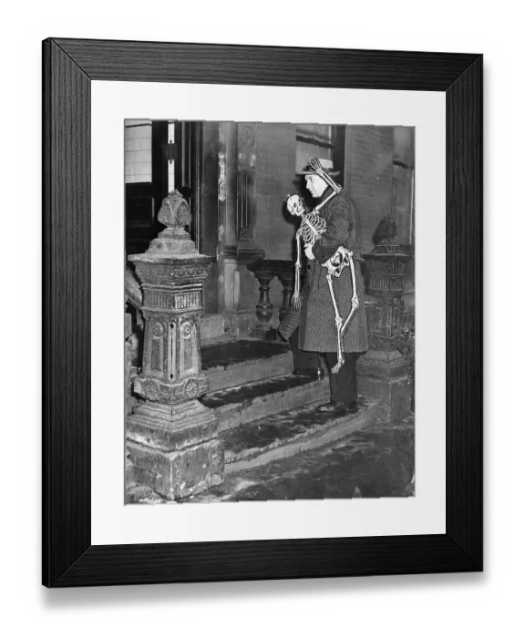 Framed Print : Man Carries Skeleton Into Building Framed Print : Man Carries Skeleton Into Building
