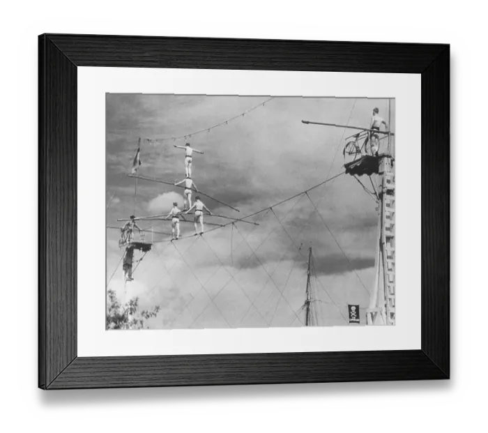Framed Print : Human Pyramid Moving Across Tightrope Framed Print : Human Pyramid Moving Across Tightrope