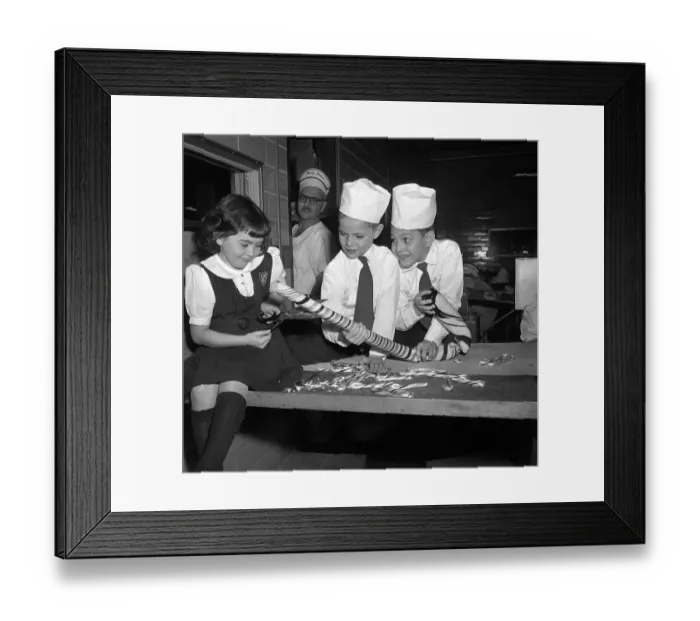 Framed Print : Children (10-12) preparing large candy cane Framed Print : Children (10-12) preparing large candy cane