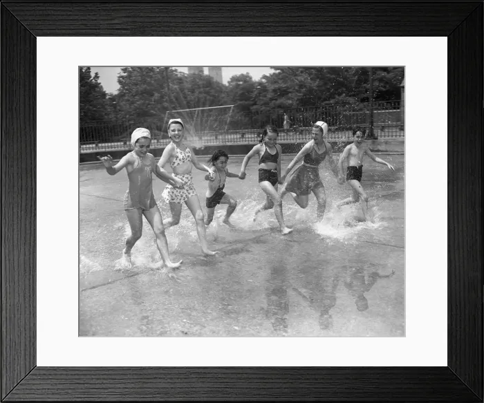 Framed Print : Children (8-9, 10-12) holding hands, running over water