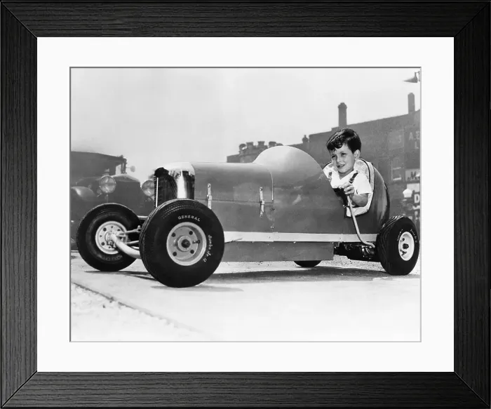 Framed Print : Young boy (8-9) sitting in go cart Framed Print : Young boy (8-9) sitting in go cart