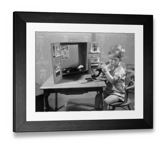 Framed Print : Boy (8-9) playing with microscope Framed Print : Boy (8-9) playing with microscope