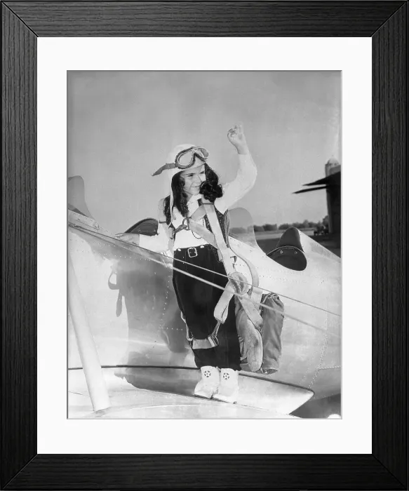 Framed Print : Young girl (8-9) standing on aeroplane wing Framed Print : Young girl (8-9) standing on aeroplane wing