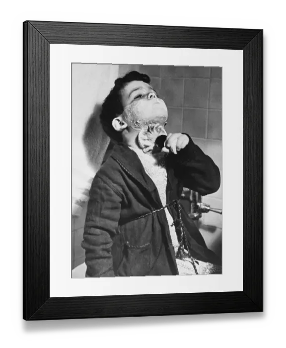 Framed Print : Boy in bathrobe using shave cream Framed Print : Boy in bathrobe using shave cream