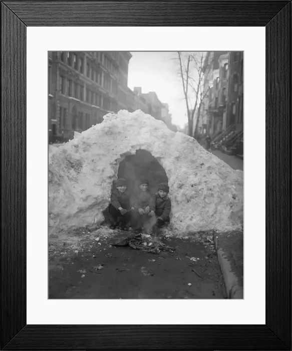 Framed Print : Three children (4-7) sitting by fire in snowy street