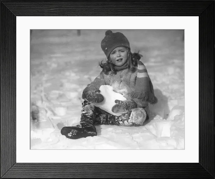 Framed Print : Portrait of girl (6-7) playing in snow Framed Print : Portrait of girl (6-7) playing in snow