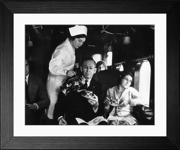Framed Print : Flight Attendant Pours Passengers Coffee Framed Print : Flight Attendant Pours Passengers Coffee