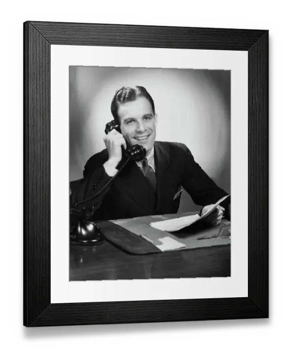Framed Print : Good News. A businessman smiling during a phone call at his desk, circa 1940 Framed Print : Good News. A businessman smiling during a phone call at his desk, circa 1940