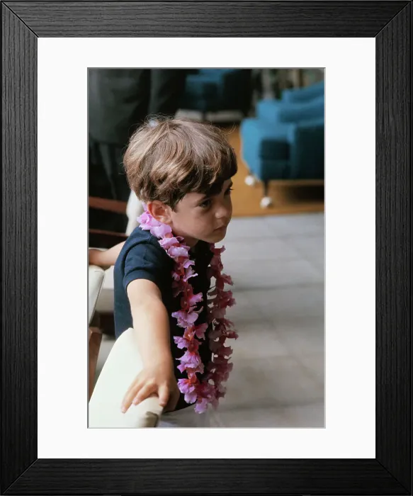 Framed Print : Young John F. Kennedy Jr. Standing on Balcony and Wearing a Lei Framed Print : Young John F. Kennedy Jr. Standing on Balcony and Wearing a Lei