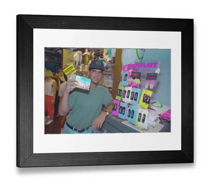 Framed Print : Store Owner Holding Condom Box